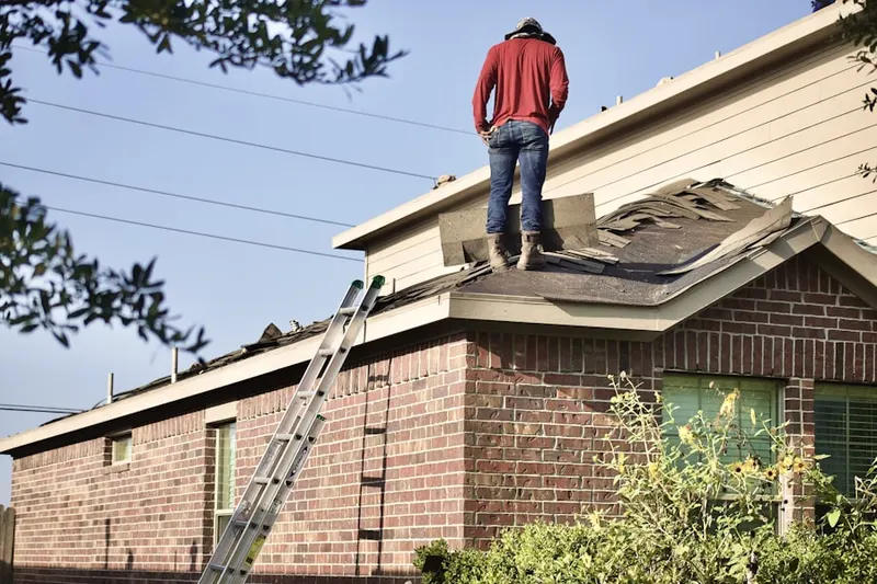 Professional roofer working on a residential roof in Capay